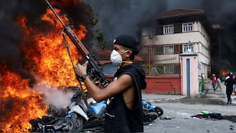 File-A demonstrator carrying a weapon takes part in a protest in Kathmandu, Nepal. Reuters
