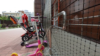 Bicycles and scooters are parked near a nursery, with netting installed on its faсade, to protect it from Ukrainian drone attacks amid Russia-Ukraine military conflict, in Belgorod, Russia, August 26, 2025. Reuters