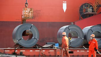 (File) Workers load steel products for export to a cargo ship at a port in Lianyungang, Jiangsu province, China. Reuters