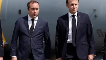 FILE PHOTO: French President Emmanuel Macron, welcomed by French Minister of Armed Forces Sebastien Lecornu, walks on the tarmac after disembarking from an Airbus A400M military plane for a visit at the 55th International Paris Airshow at Le Bourget Airport near Paris, France, June 20, 2025. REUTERS/Benoit Tessier/Pool/File Photo