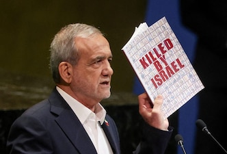 (File) Iran's President Masoud Pezeshkian holds up a book as he addresses the 80th United Nations General Assembly (UNGA) at the U.N. headquarters in New York, U on, September 24, 2025. Reuters