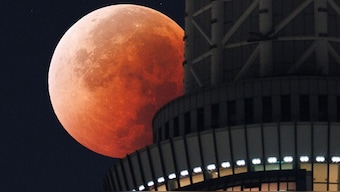 The Moon as seen from behind the Tokyo Skytree in Japan on September 8, 2025. AFP
