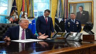 Donald Trump signs an executive order at the White House on Friday. AFP