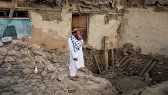 Afghan men search for their belongings amidst the rubble of a collapsed house after a deadly magnitude-6 earthquake that struck Afghanistan around midnight, in Dara Mazar, in Kunar province, Afghanistan, on Monday. Reuters 