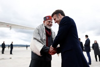 French President Emmanuel Macron (R) shakes hands with Indian Prime Minister Narendra Modi after a departure ceremony at Marseille Provence airport in Marignane as part of a visit in Marseille, France, February 12, 2025. (Photo by Christian Hartmann / POOL / AFP)