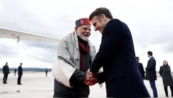 French President Emmanuel Macron (R) shakes hands with Indian Prime Minister Narendra Modi after a departure ceremony at Marseille Provence airport in Marignane as part of a visit in Marseille, France, February 12, 2025. (Photo by Christian Hartmann / POOL / AFP)