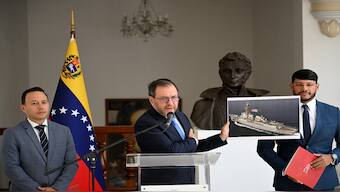Venezuela's Foreign Minister Yvan Gil shows a picture of a boat bearing a US flag during a press conference at the Ministry of Foreign Affairs in Caracas on September 13, 2025. AP