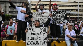 Protesters take part in a rally as they demonstrate against corruption following the revelations over bogus flood control projects, one of the country's biggest corruption scandals in decades, at the People Power Monument in Quezon City, Metro Manila on September 21, 2025. Thousands of Filipinos marched in Manila on September 21 to vent their anger over a ballooning scandal involving bogus flood-control projects believed to have cost taxpayers billions of dollars. (Photo by Jam STA ROSA / AFP)
