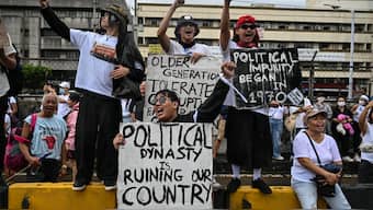 Protesters take part in a rally as they demonstrate against corruption following the revelations over bogus flood control projects, one of the country's biggest corruption scandals in decades, at the People Power Monument in Quezon City, Metro Manila on September 21, 2025. Thousands of Filipinos marched in Manila on September 21 to vent their anger over a ballooning scandal involving bogus flood-control projects believed to have cost taxpayers billions of dollars. (Photo by Jam STA ROSA / AFP)