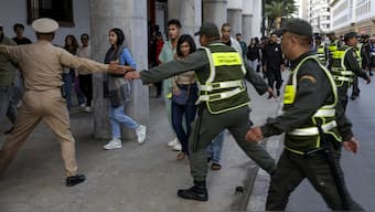 Moroccan security forces escort protesters away from the parliament building in Rabat on September 28, 2025 during a youth-led demonstration for social justice and demanding improvements to the public health and education sectors. (Photo by Abdel Majid BZIOUAT / AFP)