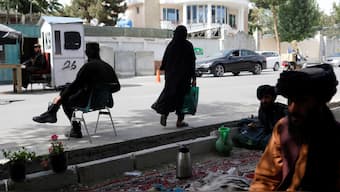 An Afghan woman walks among Taliban soldiers at a checkpoint in Kabul, Afghanistan, July 6, 2023. File Image/Reuter