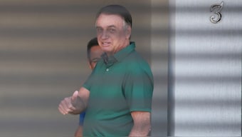Brazil's former President Jair Bolsonaro flashes a thumbs up while standing at the entrance of his home where he is under house arrest in Brasilia, Brazil, Thursday, September 11, 2025. File Image/AP