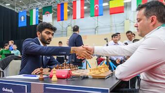 India's D Gukesh shakes French GM Etienne Bacrot. Image credit: FIDE/Michal Walusza