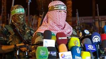 Abu Obeida (right), spokesman for the armed wing of Hamas, the Ezzedine al-Qassam Brigades, delivers a statement in Gaza City late on July 8, 2015. (Photo: Mohammed Abed/AFP)