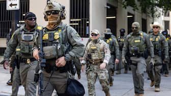 Federal agents from US Immigration and Customs Enforcement (ICE) and US Customs and Border Protection (CBP) walk north on North Clark Street in the River North neighborhood, Sunday, Sept. 28, 2025, in Chicago. (Photo: Ashlee Rezin/Chicago Sun-Times via AP)