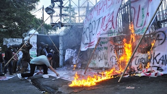 Protesters throw bamboo sticks while setting banners on fire at the gate of the regional parliament building during a protest against the government's spending priorities, such as enhanced perks for lawmakers, in Bandung, West Java province, Indonesia, September 1, 2025. File Image/Reuters