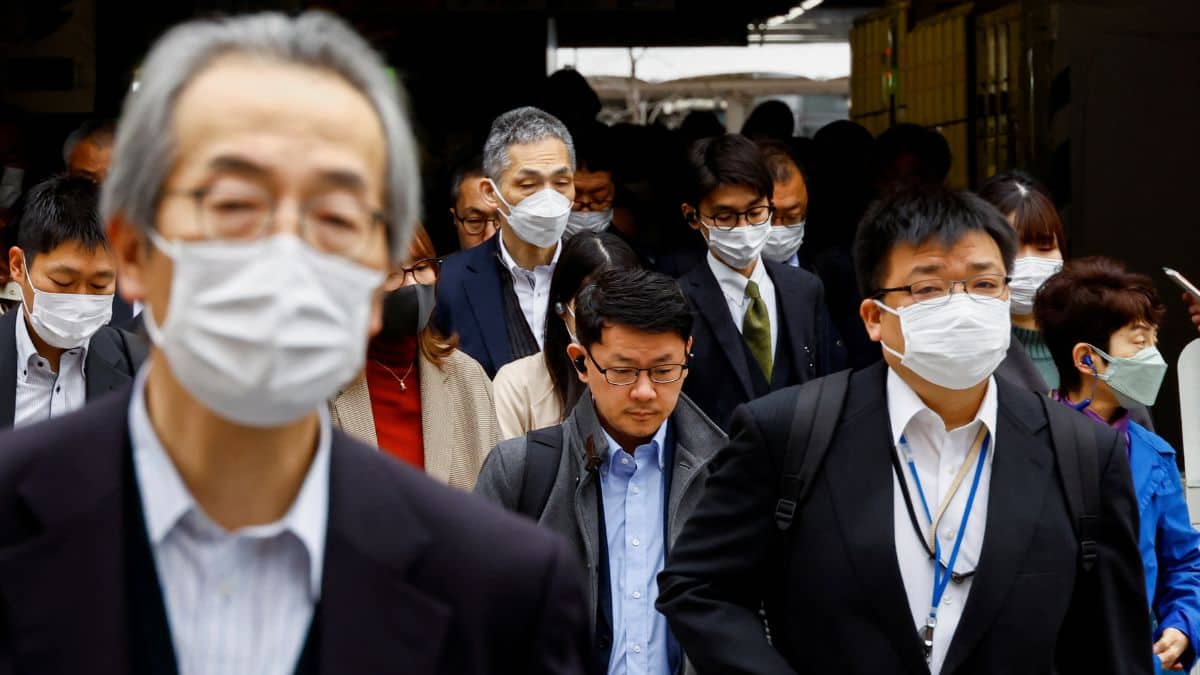 Commuters make their way on the first day of the Japanese government's relaxation of official guidance on masks as it emerges from the Covid-19 pandemic, in Tokyo, Japan, March 13, 2023. File Image/Reuters