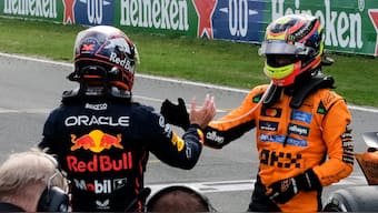 McLaren's Oscar Piastri (right) shakes Red Bull Racing's Max Verstappen's hand after the two finished first and second respectively at the Dutch Grand Prix. AP