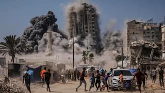Palestinians run for cover during an Israeli airstrike on a high-rise building in Gaza City, Friday, Sept. 5, 2025, after the Israeli army issued a prior warning.
- AP