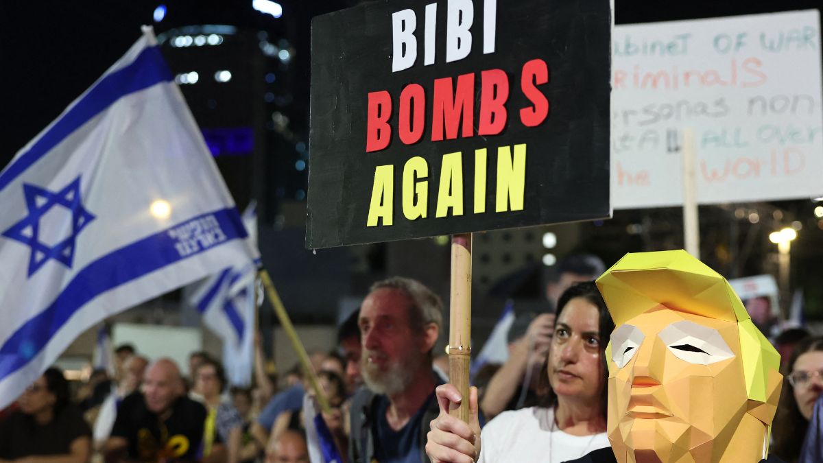 A protester wearing a mask representing US President Donald Trump carries a sign during a demonstration organised by the families of Israelis held hostage by Palestinian militants in the Gaza Strip, to call for their release and for a ceasefire in the war in Gaza, at 'Hostage Square' in Tel Aviv on September 13, 2025. Image- AFP A protester wearing a mask representing US President Donald Trump carries a sign during a demonstration organised by the families of Israelis held hostage by Palestinian militants in the Gaza Strip, to call for their release and for a ceasefire in the war in Gaza, at 'Hostage Square' in Tel Aviv on September 13, 2025. Image- AFP