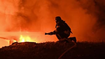 A firefighter works to extinguish a fire at the site of a drone attack late night in Kharkiv on September 23, 2025, amid the Russian invasion of Ukraine. (AFP)