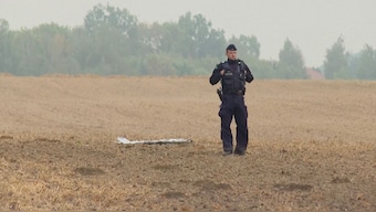 A Polish police officer stands near a unmanned aerial vehicle (UAV) fragment, after Russian drones violated Polish airspace during an attack on Ukraine and some were shot down by Poland, in Czesniki, Lublin Voivodeship, Poland, September 10, 2025 in this still image from video. Reuters File