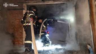 In this photo provided by the Ukrainian Emergency Services on Tuesday, Sept. 16, 2025, rescue workers put out a fire of a house destroyed by a Russian strike in Sumy region, Ukraine. (Ukrainian Emergency Service via AP)