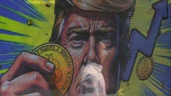 An illustration featuring US President Donald Trump holding Bitcoin is displayed outside a cryptocurrency exchange store after Bitcoin soars above $100,000, in Hong Kong, China, December 5, 2024. File Image/Reuters