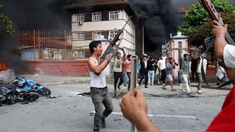 Demonstrators carrying weapons, taken from the supreme court, take part in a protest against Monday's killing of 19 people after anti-corruption protests that were triggered by a social media ban, outside the supreme court in Kathmandu, Nepal September 9, 2025. Reuters