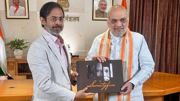 Union Minister Amit Shah presented Network18's coffee table book capturing PM Modi's life