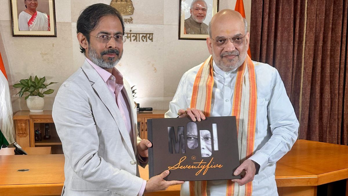 Union Minister Amit Shah presented Network18’s coffee table book capturing PM Modi’s life