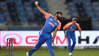 Empty stands can be seen in the background as Jasprit Bumrah bowls in India's Asia Cup match. Image: AFP