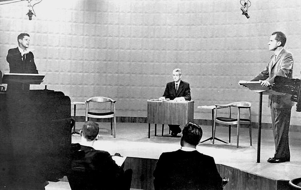 Democrat Senator John Kennedy (left) and Republican Richard Nixon stand at lecterns as they debated on campaign issues at a Chicago television studio. Wikimedia Commons