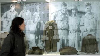 A visitor walks past the images and old uniforms of the Flying Tigers from World War II, who were led by late General Claire L. Chennault at the Anti-Japanese War Museum in Dayi county in China's southwestern province of Sichuan, The museum holds more than 20,000 artifacts which exhibit the history of China's war of resistance against Japanese invasion during 1937 to 1945. File photo/AFP 