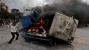 Demonstrators burn furniture and a police booth outside Nepali Congress party office during a protest against Monday's killing of 19 people, after anti-corruption protests that were triggered by a social media ban which was later lifted, during a curfew in Kathmandu, Nepal. Reuters