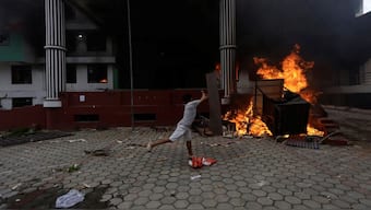 A demonstrator throws a wooden plank towards flames, outside Nepali Congress party office during a protest against Monday's killing of 19 people, after anti-corruption protests that were triggered by a social media ban which was later lifted, during a curfew in Kathmandu, Nepal. Representative Image. Reuters