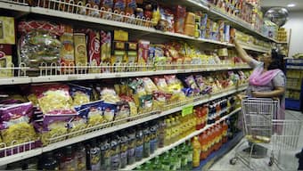 A woman shops in a grocery store in Lucknow. Household kitchens are set for relief as the GST Council has rolled out sweeping tax cuts on everyday food items. File image/Reuters

