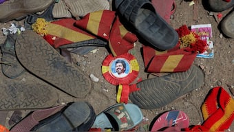 A badge with picture of Vijay, actor and politician, lies amid footwears and other belongings left by attendees at the site of a stampede incident during an election campaign rally held by Tamilaga Vettri Kazhagam party, in Karur district of Tamil Nadu, India, September 28, 2025. Reuters
