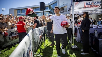 Charlie Kirk hands out hats before speaking at Utah Valley University in Orem, Utah, moments before he was shot dead. Tess Crowley/The Deseret News via AP