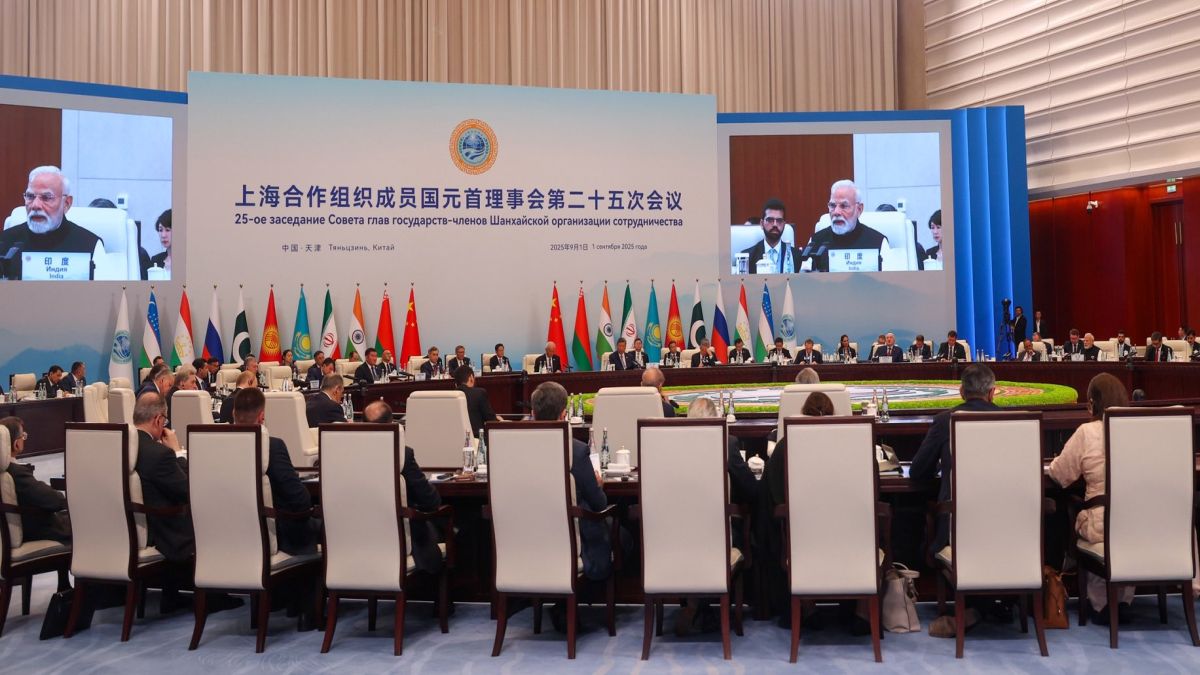 Prime Minister Narendra Modi's face is displayed on a screen as he delivers his remarks at the SCO Summit in China's Tianjin. Image Courtesy: @MEAIndia/X Prime Minister Narendra Modi's face is displayed on a screen as he delivers his remarks at the SCO Summit in China's Tianjin. Image Courtesy: @MEAIndia/X