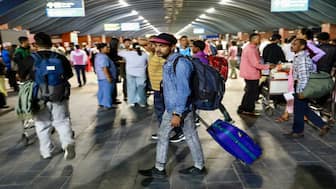 Passengers walk with luggage through Tribhuvan International Airport after it reopened in Kathmandu on September 10, 2025, following a closure due to civil unrest in Nepal's capital. Nepal's army took back control of Kathmandu on September 10 after the worst violence in two decades ousted the prime minister and left the parliament ablaze, enforcing a curfew and starting talks with protest leaders. AFP