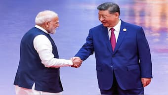 Prime Minister Narendra Modi and China's President Xi Jinping shake hands during the welcome ceremony of the SCO summit in Tianjin. AFP
