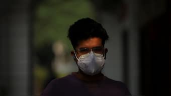 A man walks with a face mask on a smoggy morning after the air quality dipped, partly due to the use of firecrackers during Diwali in New Delhi, October 23, 2025. Reuters