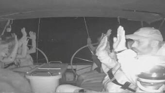 The crew of one of the Gaza-bound vessels with their hands up as they are boarded by Israeli military.  Reuters