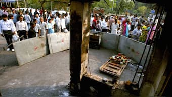 Residents and shopkeepers gather around the site of Saturday's bomb blast in New Delhi. Reuters