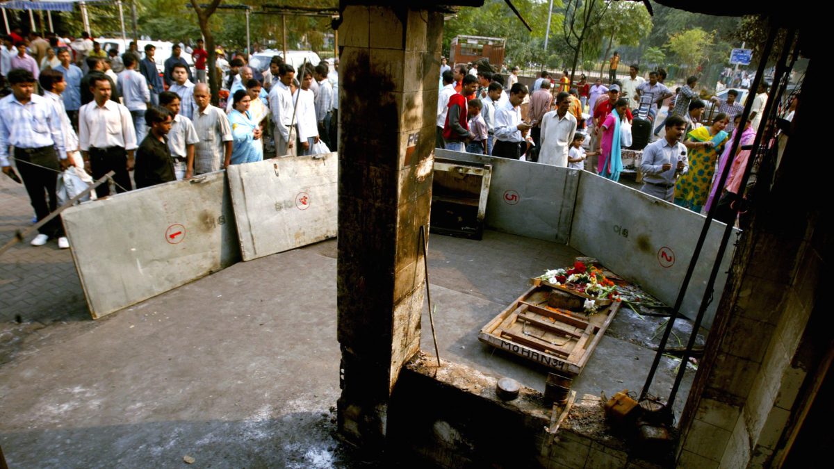 Residents and shopkeepers gather around the site of Saturday's bomb blast in New Delhi. Reuters Residents and shopkeepers gather around the site of Saturday's bomb blast in New Delhi. Reuters