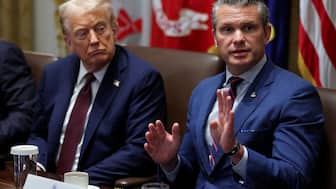 FILE PHOTO: U.S. President Donald Trump and Defense Secretary Pete Hegseth attend a cabinet meeting at the White House in Washington, D.C., U.S., August 26, 2025. REUTERS/Jonathan Ernst/File Photo