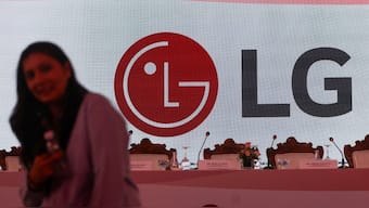 (File) A woman stands in front of the LG Electronics logo ahead of the company's IPO announcement in Mumbai on October 1, 2025. Reuters