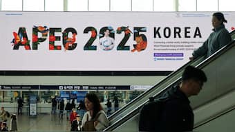 Passengers ride on escalators as a large electric board shows an advertisement promoting the 2025 Asia-Pacific Economic Cooperation leaders' summit in Gyeongju, at a railway station in Seoul, South Korea. Reuters