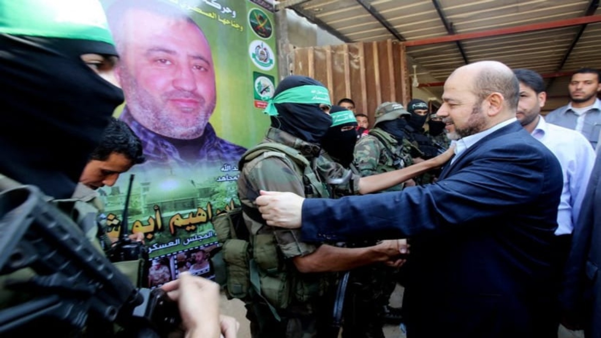 Hamas political leader Musa Abu Marzouk (R) shakes hands with a Hamas militant as he visits the mourning tent of senior Hamas commander Mohammed Abu Shammala (seen in posters). File Image / Reuters Hamas political leader Musa Abu Marzouk (R) shakes hands with a Hamas militant as he visits the mourning tent of senior Hamas commander Mohammed Abu Shammala (seen in posters). File Image / Reuters